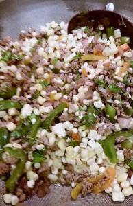 Saute onion and peppers until soft, then brown beef and stir in corn. Season with salt, pepper and fresh herbs