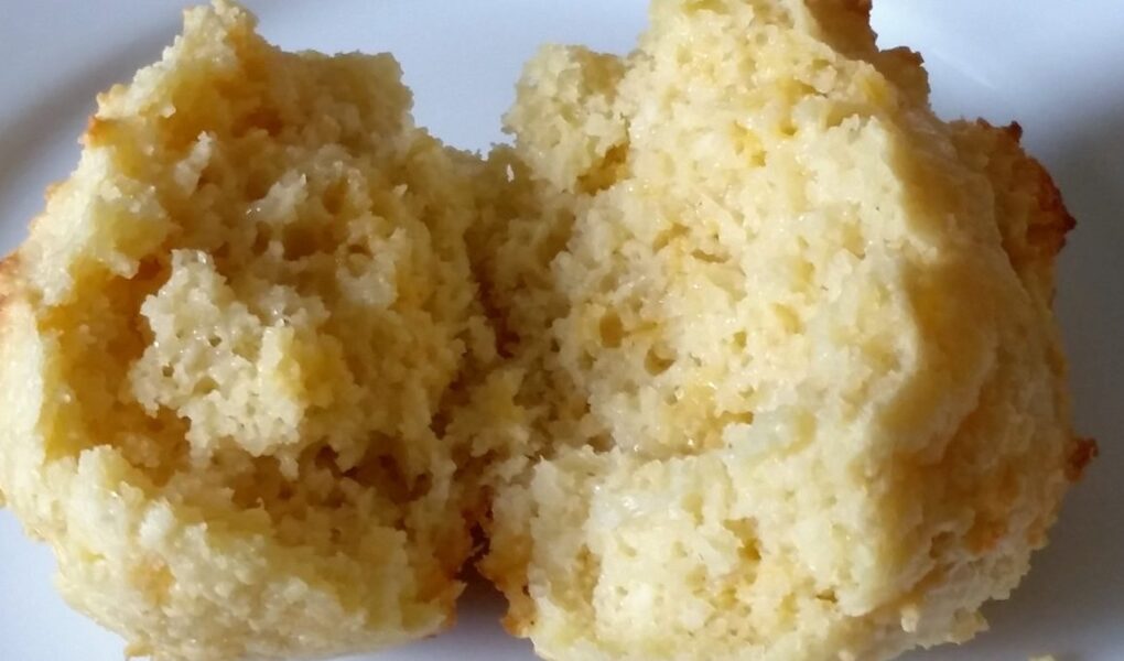 Finished biscuit sliced in half and laid open to show texture on a white plate