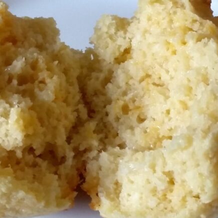 Finished biscuit sliced in half and laid open to show texture on a white plate