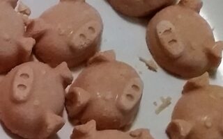 Close up of fat bombs extracted from ice trays, pig face shaped