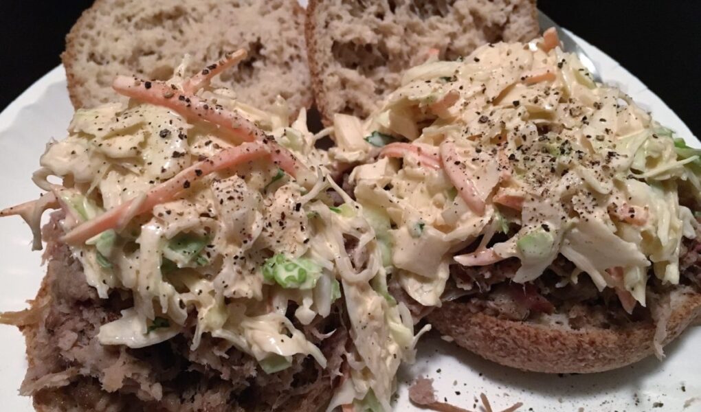 Low Carb Coleslaw served on low carb english muffins on white paper plate