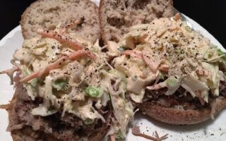 Low Carb Coleslaw served on low carb english muffins on white paper plate