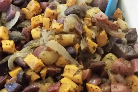 Finished four potato salad in white serving dish and tongs