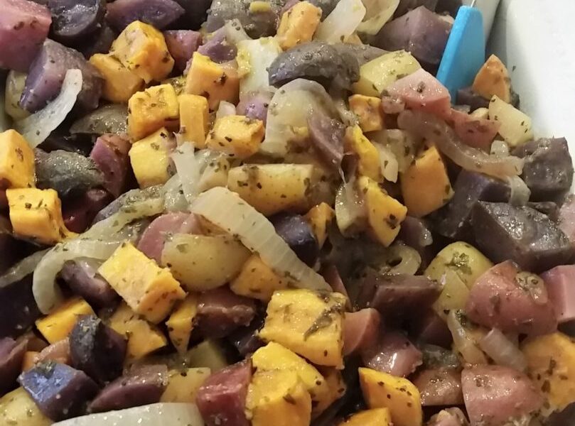 Finished four potato salad in white serving dish and tongs
